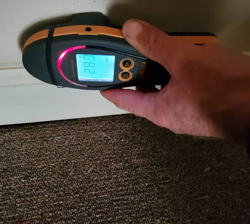 Moisture detection at baseboard during Storm Damage Restoration in Sunset